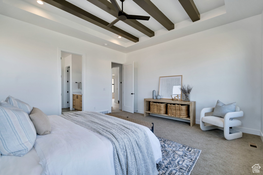 Carpeted bedroom with ensuite bath, beam ceiling, and ceiling fan