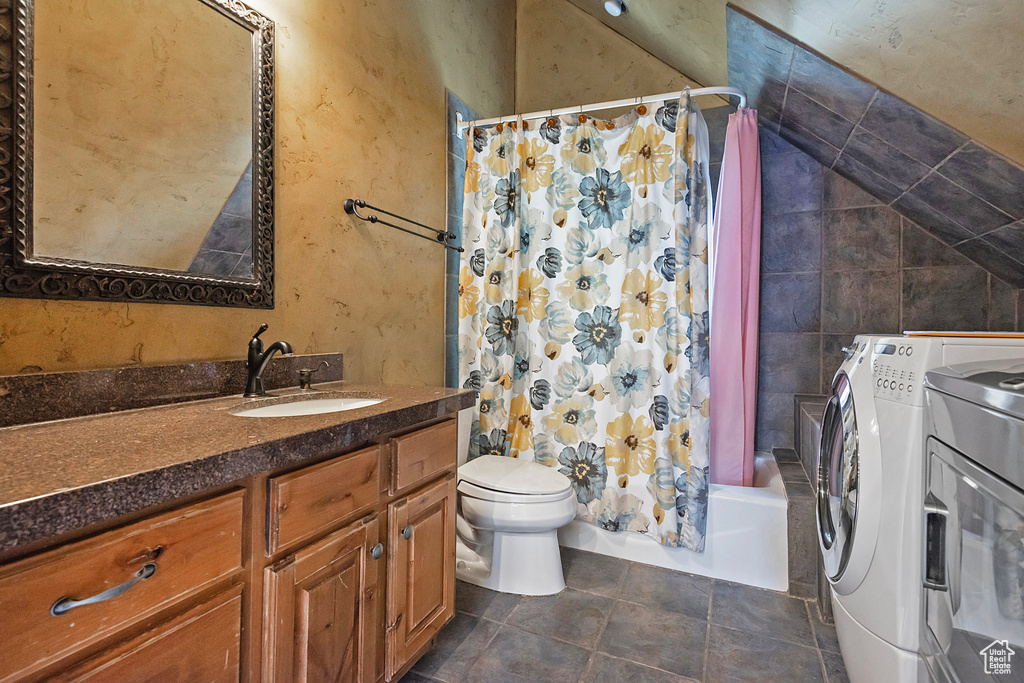 Full bathroom featuring shower / bath combination with curtain, tile floors, separate washer and dryer, vanity, and toilet