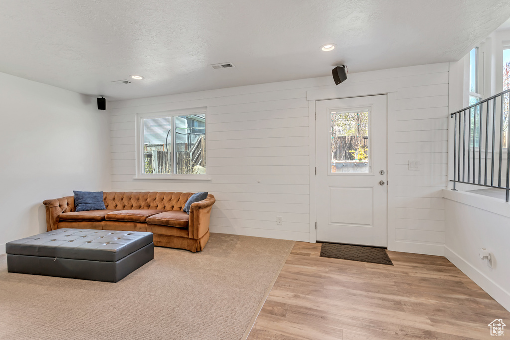 Entrance foyer with light hardwood / wood-style flooring and a wealth of natural light