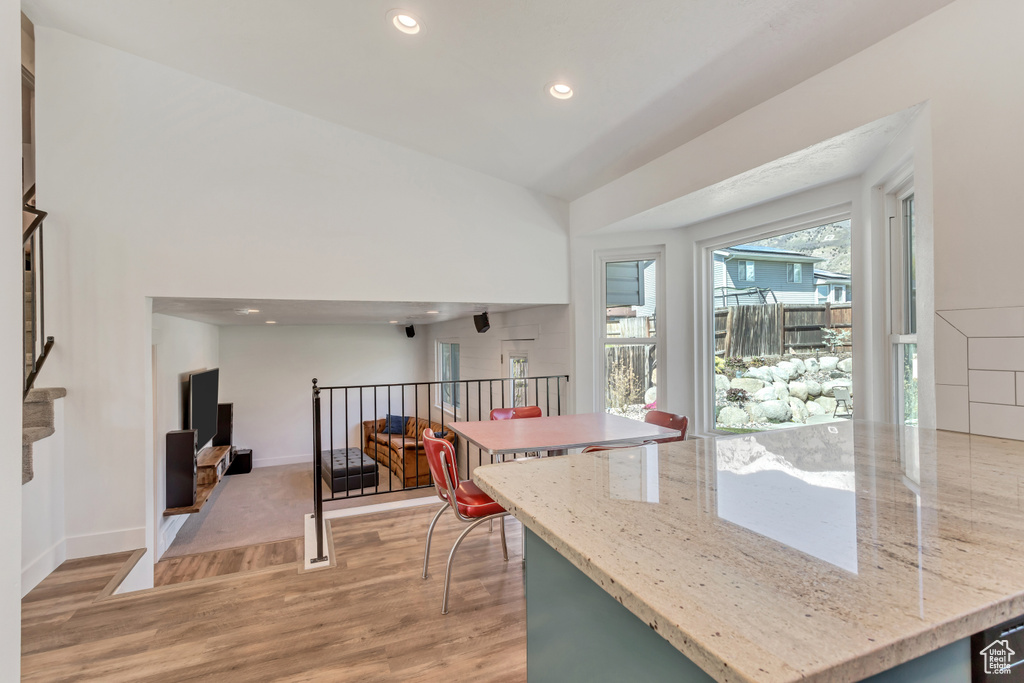Kitchen featuring light hardwood / wood-style floors and light stone countertops