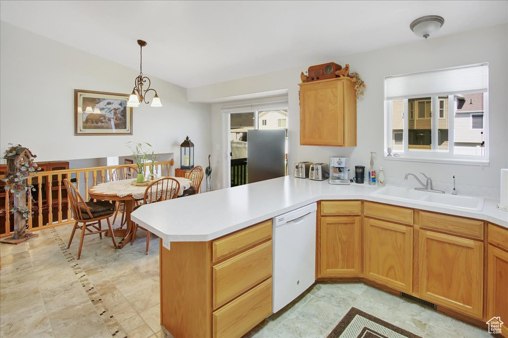 Kitchen with a wealth of natural light, dishwasher, and light tile floors