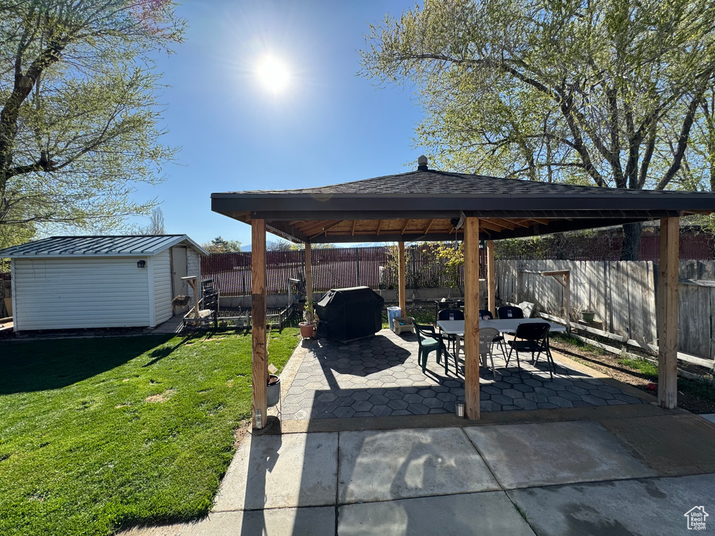 View of patio featuring a gazebo and a storage unit