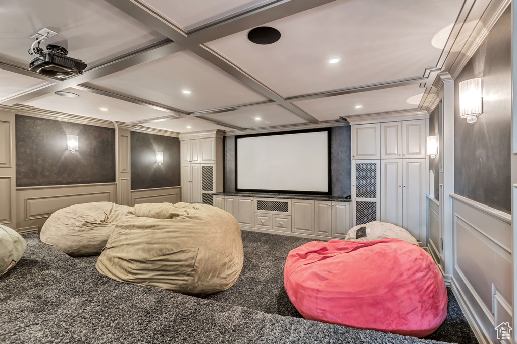 Home theater room with carpet flooring and coffered ceiling