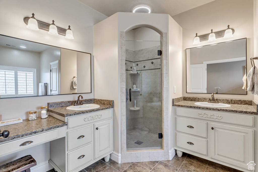 Bathroom featuring an enclosed shower, tile flooring, and large vanity