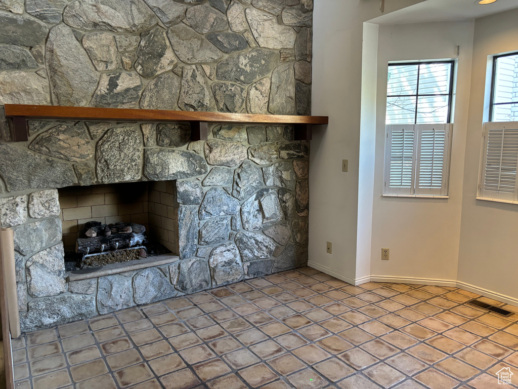 Room details featuring a fireplace and tile flooring