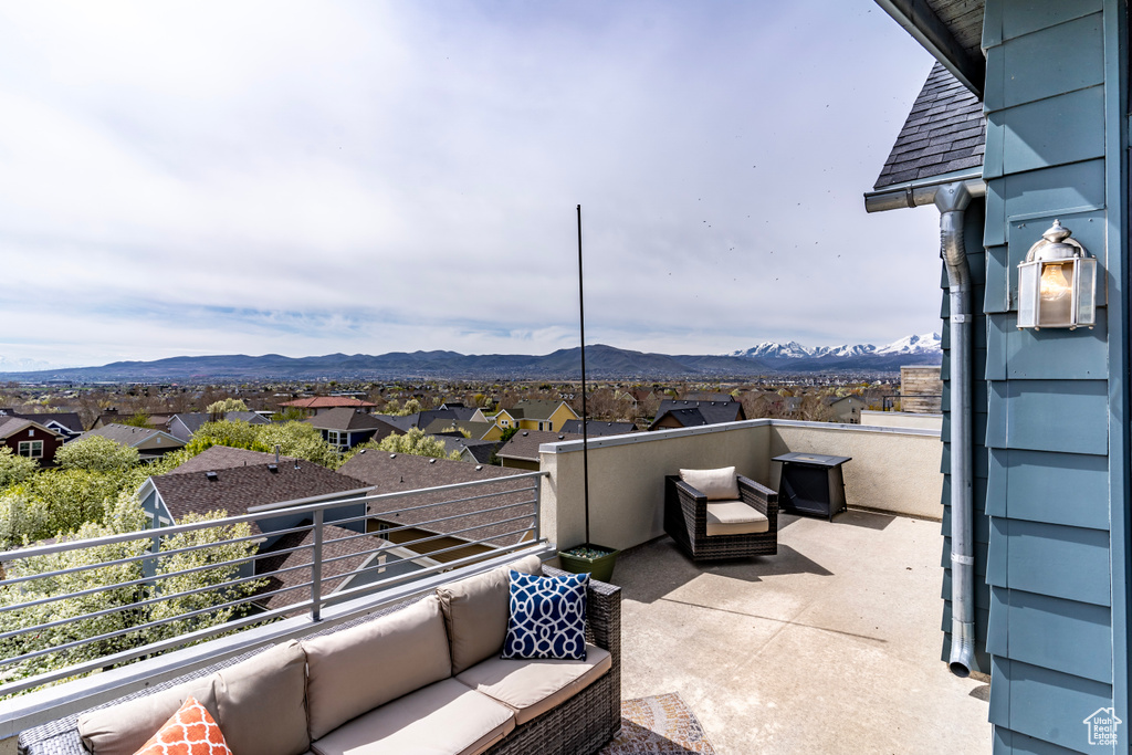 View of terrace featuring an outdoor living space, a mountain view, and a balcony