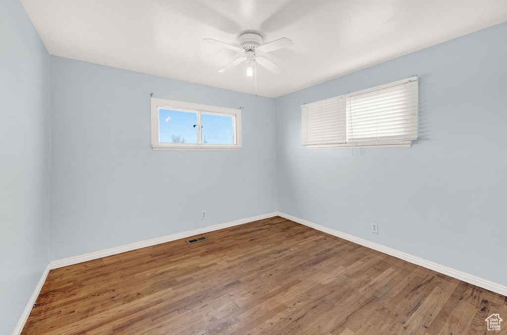 Spare room featuring ceiling fan and hardwood / wood-style flooring