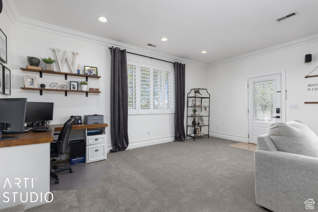 Carpeted home office featuring crown molding