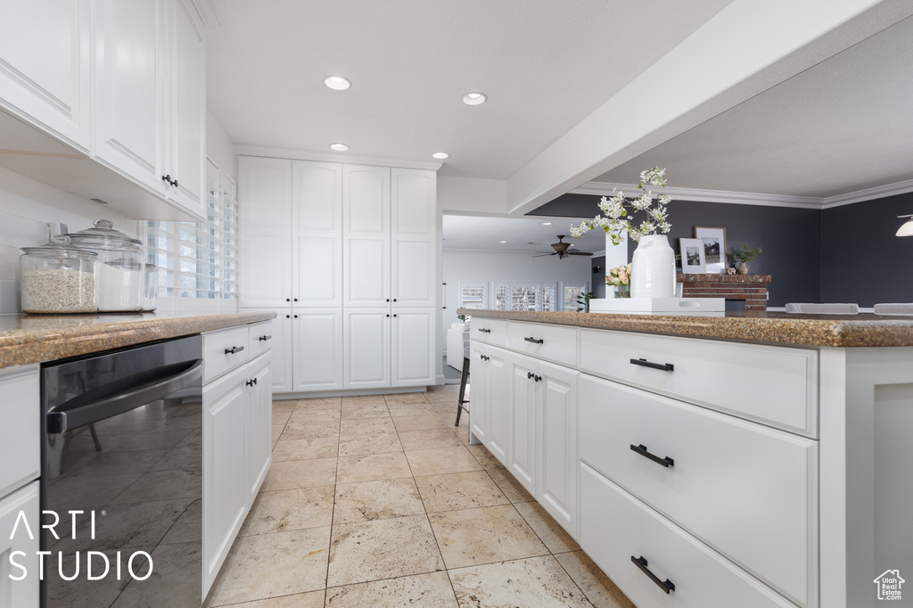 Kitchen featuring ceiling fan, black dishwasher, white cabinetry, light tile floors, and ornamental molding