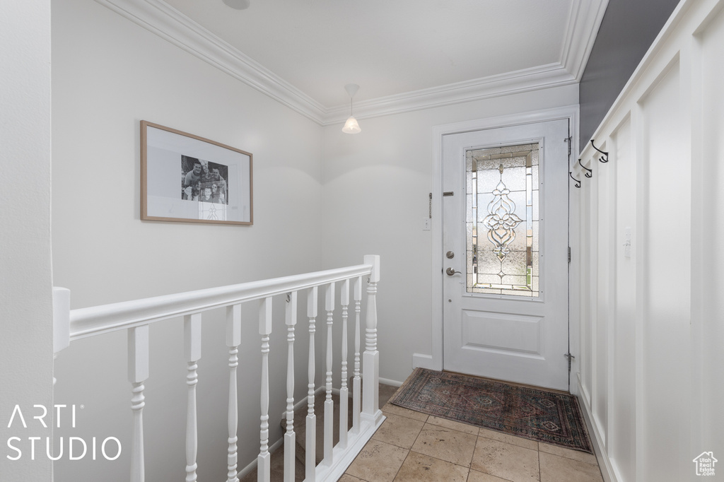 Entryway featuring crown molding and light tile floors
