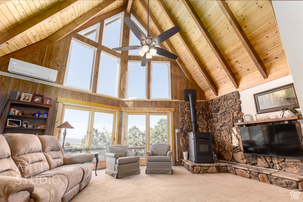 Living room with high vaulted ceiling, wooden ceiling, a wood stove, and carpet floors