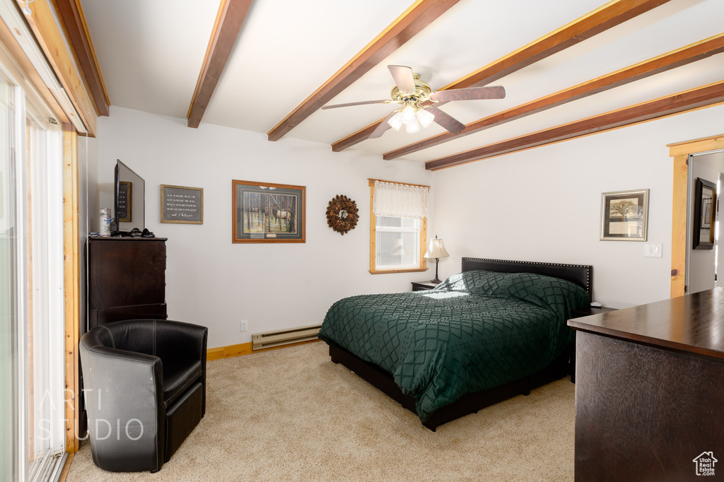 Carpeted bedroom with beamed ceiling, ceiling fan, and baseboard heating