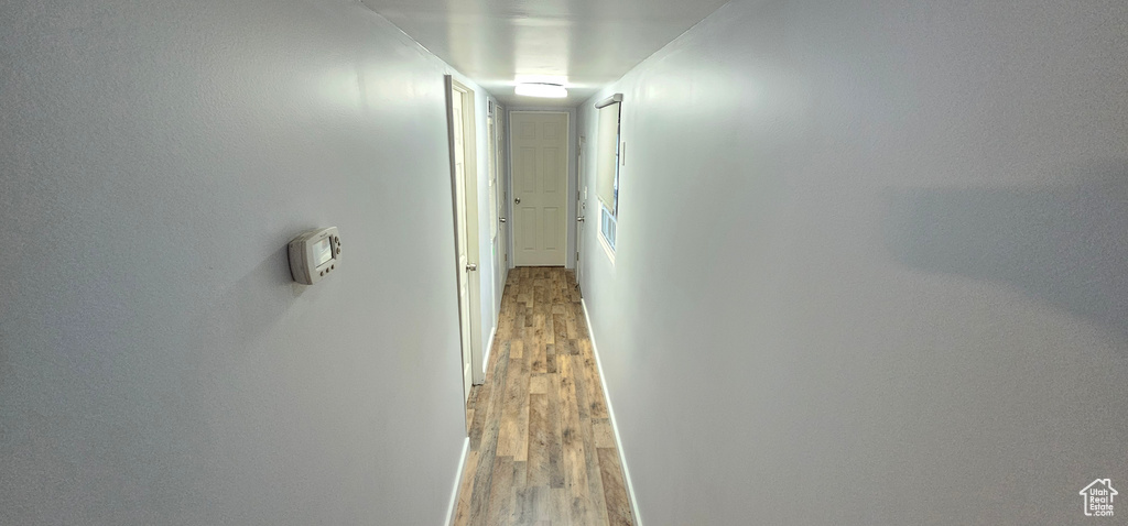 Hallway with wood-type flooring
