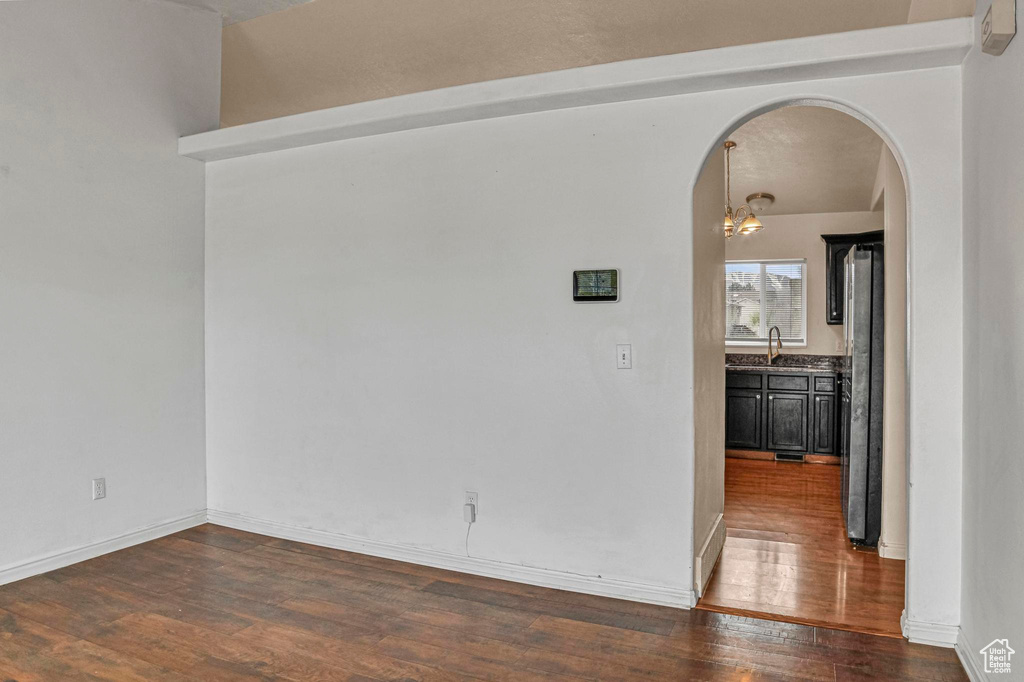 Empty room with hardwood / wood-style floors and sink