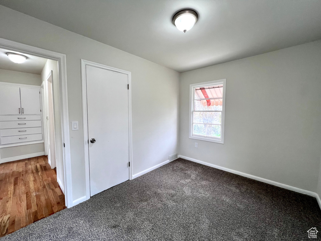 Unfurnished bedroom featuring a closet and carpet flooring