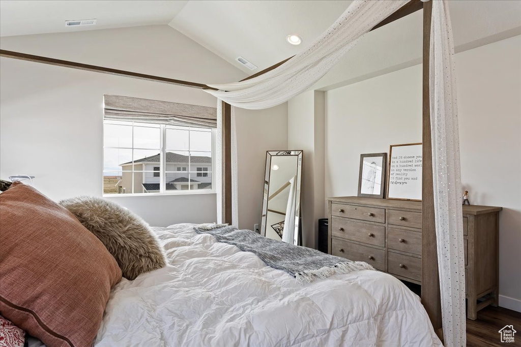 Bedroom featuring lofted ceiling and dark wood-type flooring