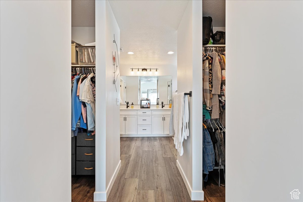 Corridor featuring sink and light hardwood / wood-style floors