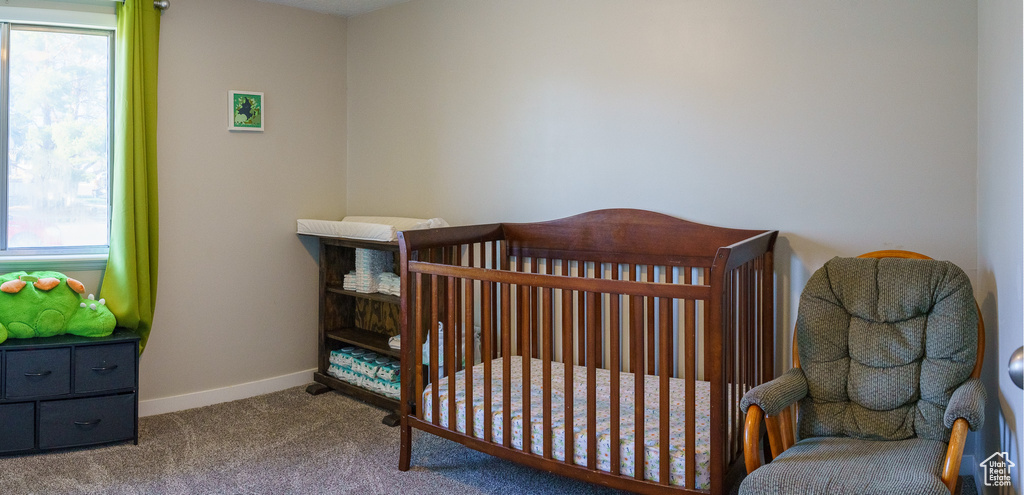 Bedroom featuring carpet and a nursery area