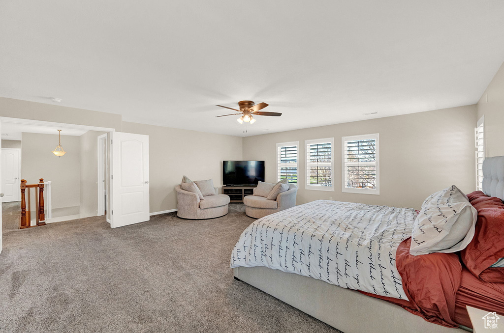 Bedroom featuring ceiling fan and carpet flooring