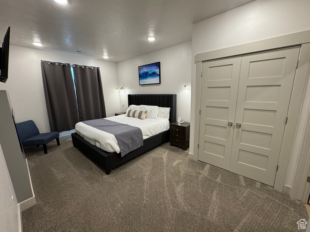 Carpeted bedroom featuring a closet