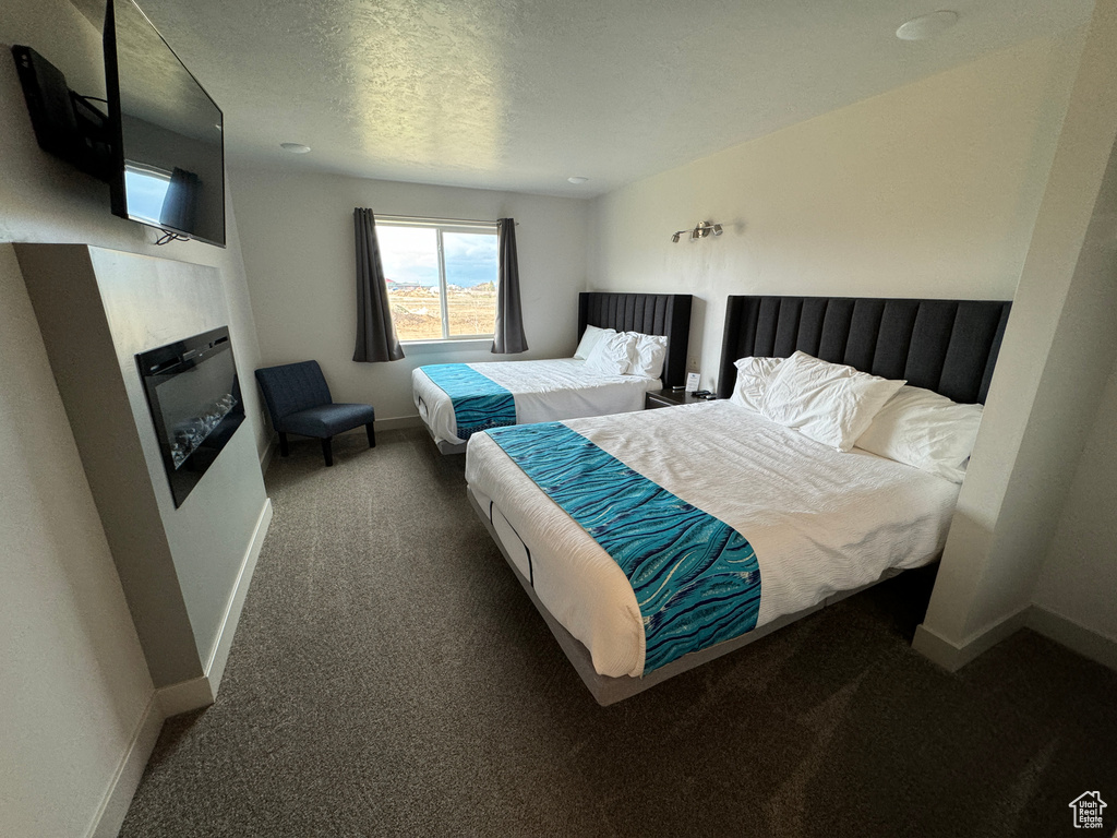 Carpeted bedroom featuring a textured ceiling