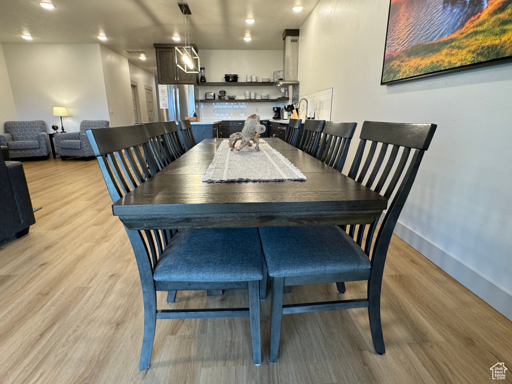 Dining room with light hardwood / wood-style flooring