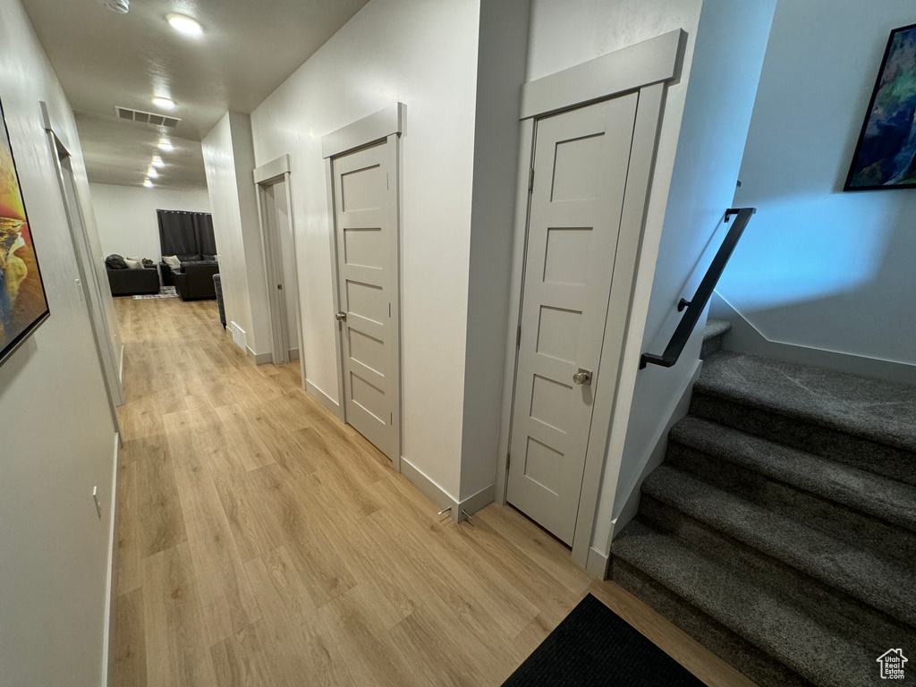 Hall featuring light hardwood / wood-style flooring