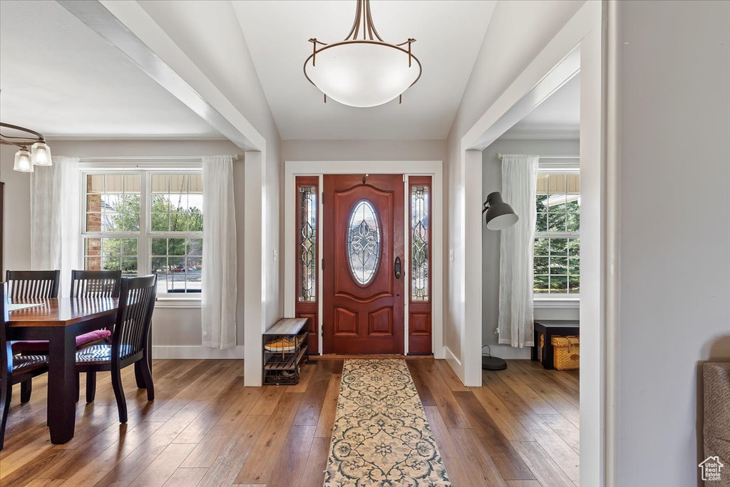 Foyer entrance featuring dark hardwood / wood-style floors and vaulted ceiling