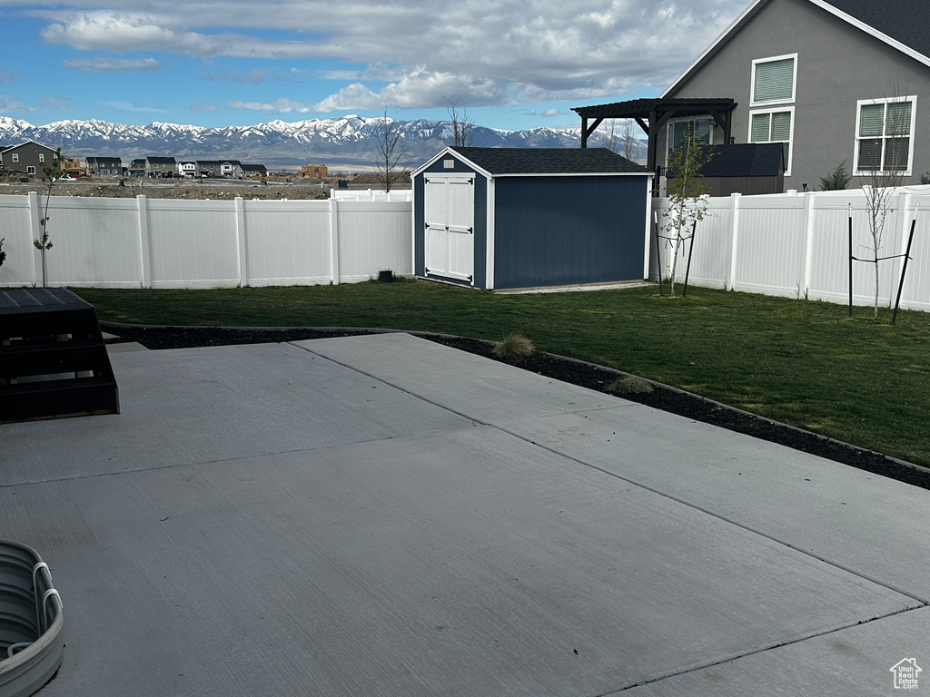 View of patio / terrace with a mountain view and a storage unit