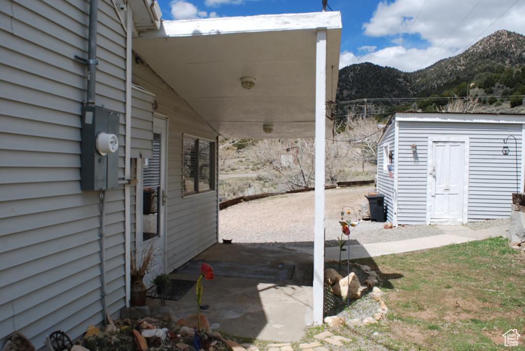 View of patio featuring a mountain view and a storage shed