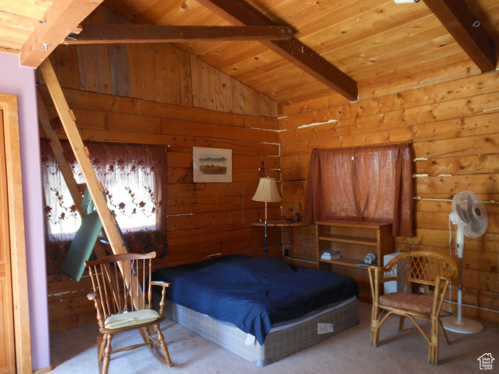 Bedroom with light colored carpet, wooden ceiling, and lofted ceiling with beams