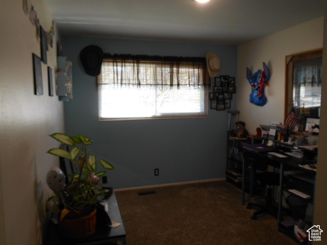 Office area featuring dark colored carpet
