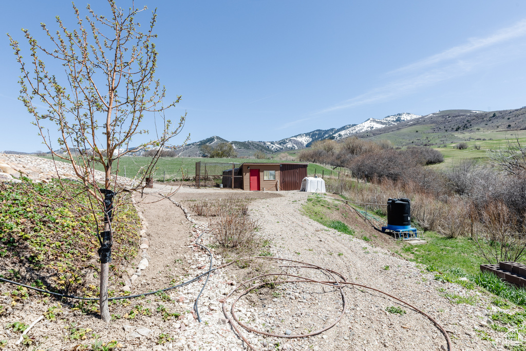 View of front of property featuring a mountain view, a rural view, and a storage unit