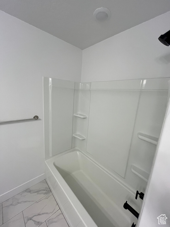 Bathroom with bathtub / shower combination and tile floors