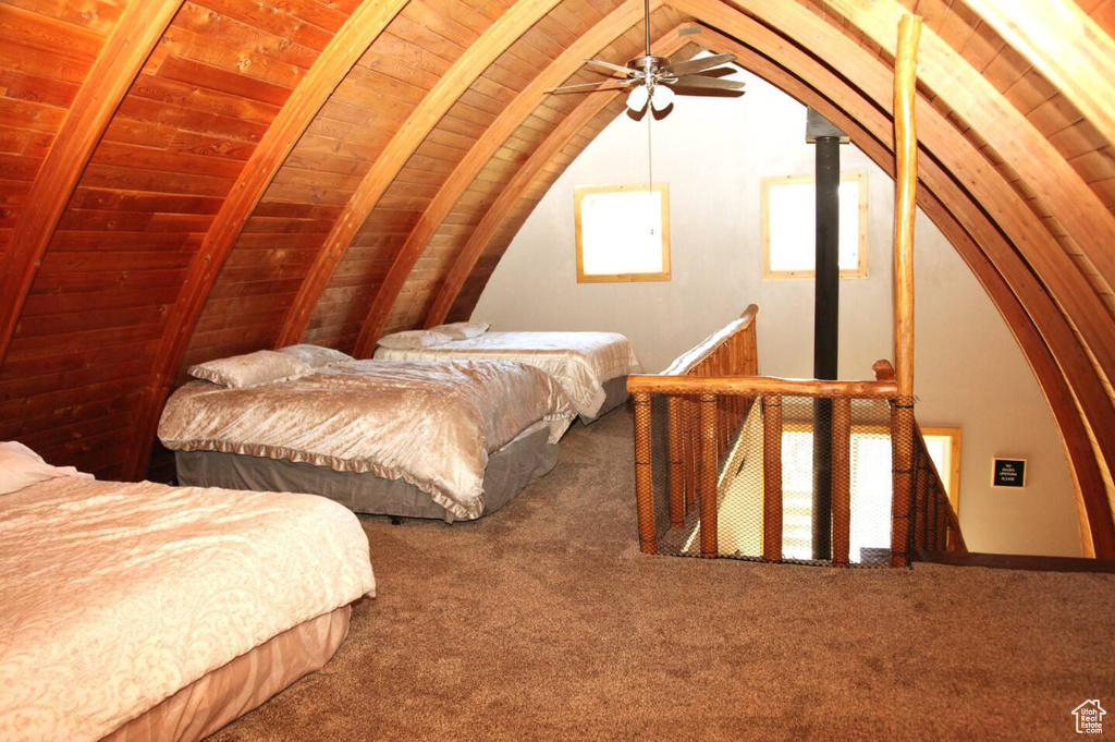Bedroom with wooden ceiling, ceiling fan, vaulted ceiling with beams, and carpet flooring