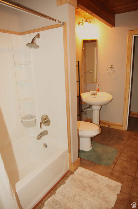 Bathroom featuring tile flooring, wood ceiling, beam ceiling, bathtub / shower combination, and toilet