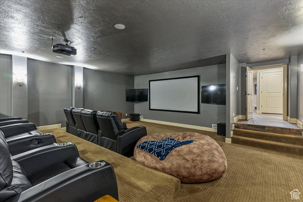 Cinema room featuring tile flooring and a textured ceiling