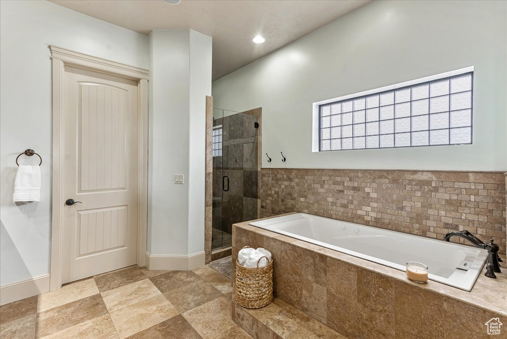Bathroom with tile flooring and independent shower and bath