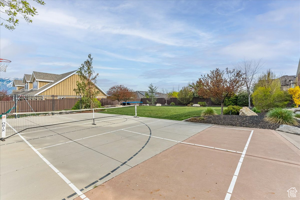 View of sport court featuring a yard