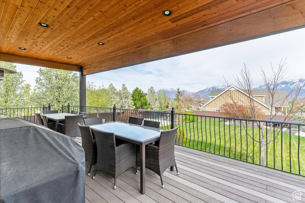 Wooden deck featuring a yard and grilling area