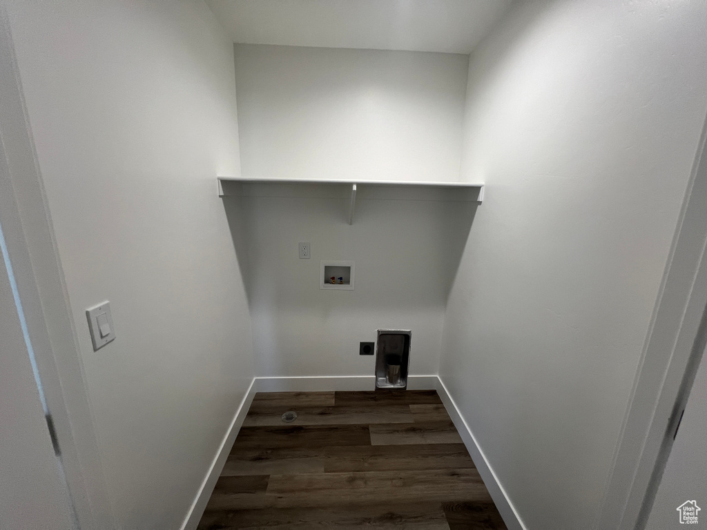 Laundry room with dark wood-type flooring and hookup for a washing machine