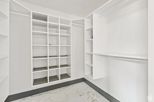 Spacious closet featuring light tile floors