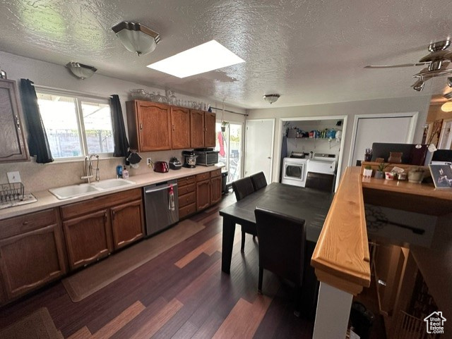 Kitchen featuring a wealth of natural light, sink, dark hardwood / wood-style flooring, and stainless steel dishwasher