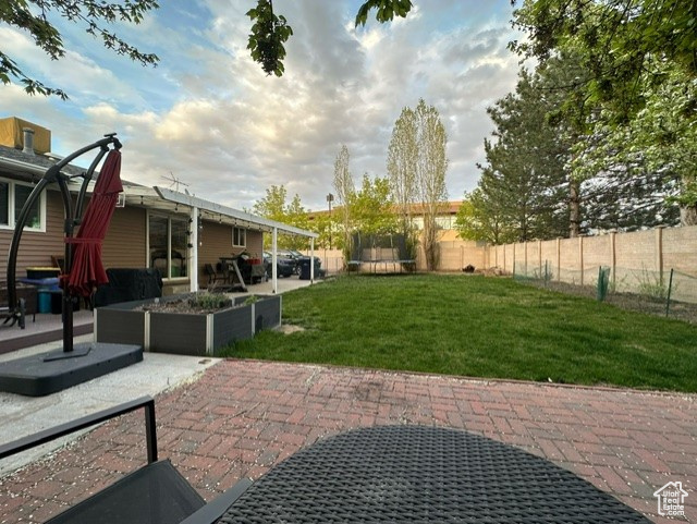 Exterior space featuring a patio and a lawn