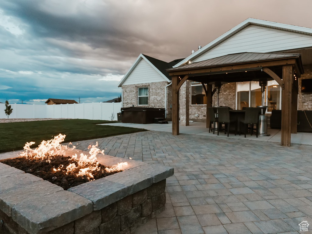 View of patio with a fire pit and a gazebo