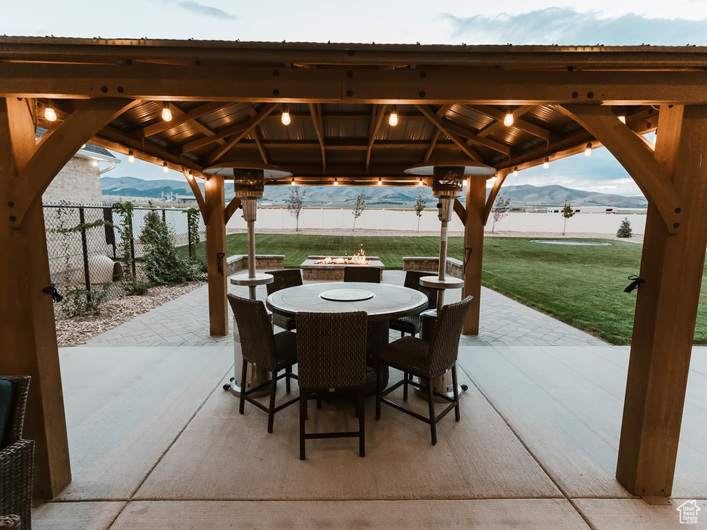 View of patio with a gazebo and a water and mountain view