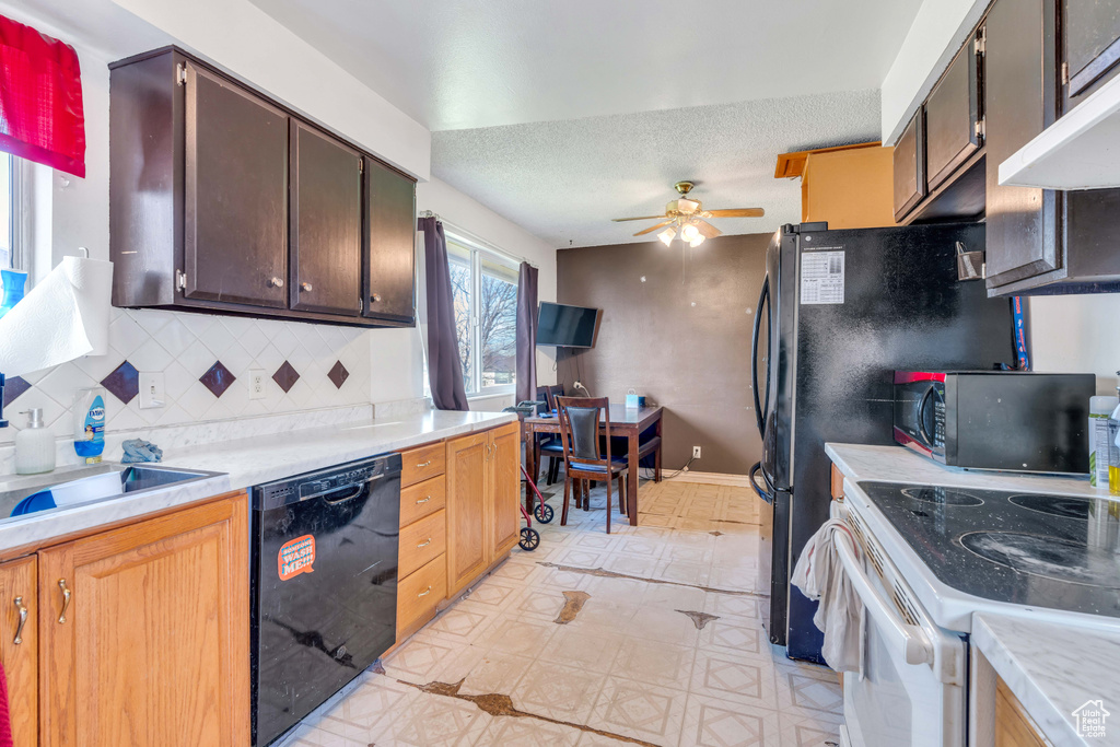 Kitchen with dark brown cabinets, ceiling fan, black appliances, tasteful backsplash, and light tile floors