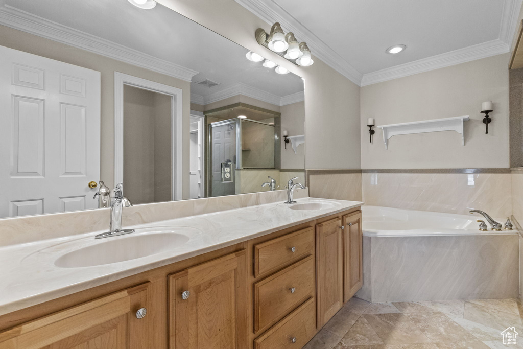 Bathroom featuring ornamental molding, oversized vanity, tile flooring, dual sinks, and plus walk in shower