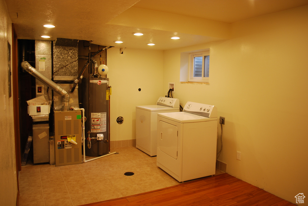 Laundry area featuring gas water heater, light tile floors, hookup for a washing machine, and separate washer and dryer