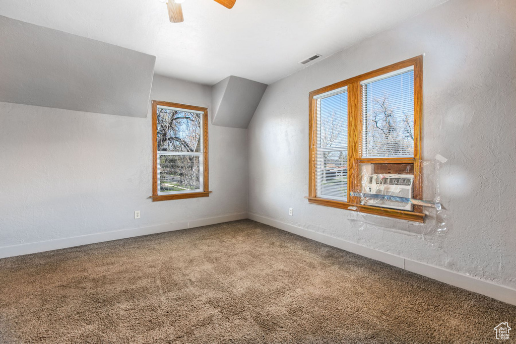 Additional living space with carpet and ceiling fan